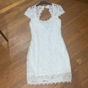 NWOT white lace dress. Body hugging open back size 9/10 juniors. Beautiful new